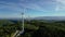 Turbine windmills for energy production. Windmills situated on a hill overgrown with trees. Drome - South of France