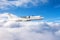 Turboprop plane flies above the clouds passenger flight, aerial view