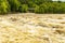 A Turbulent River with Whitecaps and Whirlpools after Spring Rain.