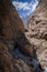 turbulent water river crossing two large rock walls of canyon duck in peru, with road on one side