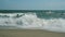 Turbulent water on a sandy coastline