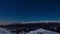 Turin city lights, panoramic night view from snow covered Alps by moonlight with clear sky. Italy.