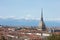Turin city rooftops, Mole Antonelliana tower and hot air balloon in a sunny day in Italy