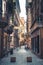 Turin, Italy, September 10, 2018: People are walking down cobble stone narrow streets