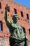 Turin, Piedmont, Italy the Archaelogical Park of Romans ruins and statue of Caesar Augustus with Torri Palatine in background