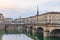 Turin street life, Italy, Torino skyline with the Mole Antonelliana and bridge on the Po River. People walking car traffic, smog a