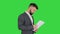 Turk businessman standing and looking at documents on a Green Screen, Chroma Key.