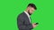Turk businessman walking and using smartphone on a Green Screen, Chroma Key.
