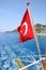 Turkey flag at the stern of a pleasure . View of Mediterranean coast