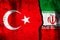 Turkey and Iran conflict, war concept. National flags background on cracked concrete wall