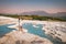 Turkey, Natural travertine pools and terraces in Pamukkale. Cotton castle in southwestern Turkey, girl in white dress