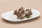 Turkey necks,  served with horseradish puree,  placed on white plate,  light background,  isolated