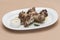 Turkey necks,  served with horseradish puree,  placed on white plate,  light background,  isolated