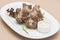 Turkey necks,  served with horseradish puree,  placed on white plate,  light background,  isolated