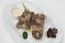 Turkey necks,  served with horseradish puree,  placed on white plate,  light background,  isolated