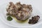 Turkey necks,  served with horseradish puree,  placed on white plate,  light background,  isolated