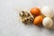 Turkey, quail and chicken eggs on hay on gray background, top view