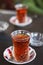 Turkish or Azerbaijani tea in pear shape glasses Armudu on a table cloth, traditional eastern hot black tea for Ramadan or Novru