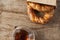 Turkish bagel Simit in paper bag with traditional tea glasses on wood table