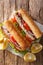 Turkish Balik Ekmek sandwich with grilled mackerel and vegetables close-up on the table. Vertical top view