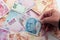 Turkish banknotes on white background and hand of adult person holding hundred lira.