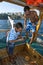 A Turkish boy removes the hook from a fishes mouth after it was caught off a cruise boat in Antalya Harbour.