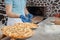 Turkish Bread Ramadan Pidesi - Round Pita Bread For Ramazan Pide. The chef lays out fresh pide, made in a traditional oven. Close-