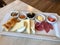 Turkish Breakfast Plate with Cheese, Various Jams, Salami, Borek and Dried Fruits.