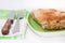 Turkish burek with meat on a green plate with fork and knife