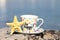 Turkish coffee cup with written be happy on it at the seaside as a summer concept