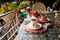 Turkish coffee cups served outside with water flowers and delight dessert in romantic setup on glass table