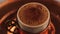 Turkish Coffee with foam in traditional glass close up