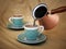 Turkish coffee poured into a traditional porcelain cup. 3D illustration