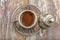 Turkish coffee in traditional silver cup on white wooden table