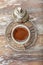 Turkish coffee in traditional silver cup on white wooden table