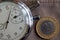 Turkish coin with a denomination of one lira (back side) and stopwatch on worn beige denim backdrop - business background