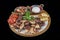 Turkish cuisine mixed kebab. Shish kebab, shaverma, grilled chicken. Dishes of oriental cuisine, lying on pita bread and decorated