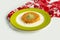 Turkish dessert kunefe, kunafa, kadayif with pistachio with walnut powder in a dish isolated on colorful table cloth top view on