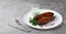 Turkish dish, Imam Bayildy, stuffed eggplant, karnyaryk, homemade, on a white plate, no people, horizontal,