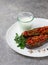 Turkish dish, Imam Bayildy, stuffed eggplant, karnyaryk, homemade, on a white plate, no people, vertical,