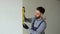 Turkish engineer builder measures of the vertical deviation of the wall. Bubble level ruler close up view, measuring and