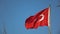 Turkish flag fluttering in the wind in the blue sky. National symbol of the state Turkey. Slow motion, Full HD video