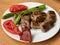 Turkish Food Kofte or Kofta / Meatballs with Green Peppers and Tomatoes.