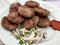 Turkish Food Kofte or Kofta / Stack of Meatballs with Onions and Hot Sauce. Kebab / Kebap