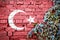 Turkish grunge flag on brick wall with ivy plant
