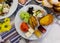 Turkish halal breakfast with cheese, olives, toasted bread, baked potatoes, vegetables