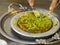 Turkish kunefe dessert in special serving dish with green pistachio