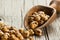 Turkish leblebi famous nut stack of yellow roasted chickpea in wooden shovel on wooden rustic background, roasted chickpeas