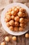 Turkish lokma donuts with honey and cinnamon close-up. Vertical