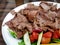 Turkish meat doner kebab with vegetables salad on a plate.